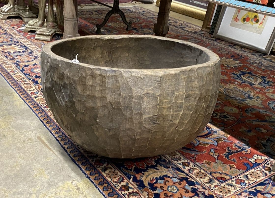 A large circular chip carved wooden bowl, diameter 64cm, height 42cm